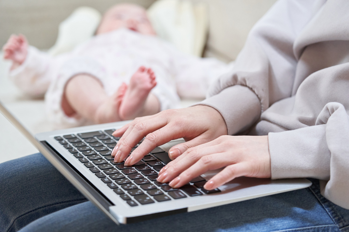 Asian mom looking up child-rearing on a computer